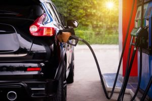 A black Hyundai ix35 being refuelled at a gas station pump, illustrating its fuel consumption.