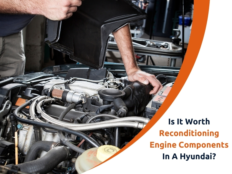 Mechanic inspecting engine components of a Hyundai.