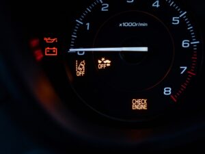 Dashboard showing check engine light, indicating potential Kia engine problems in older models.