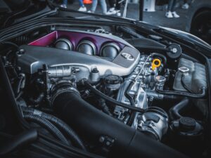 Close-up of reconditioned engine parts in a Kia vehicle's engine bay with detailed components visible.