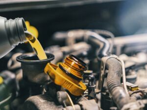 A car undergoing a reconditioning process in a workshop. Mechanics are working on the vehicle to restore it to its original condition.