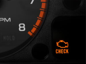 Dashboard with illuminated check engine light, indicating a possible faulty Kia engine.